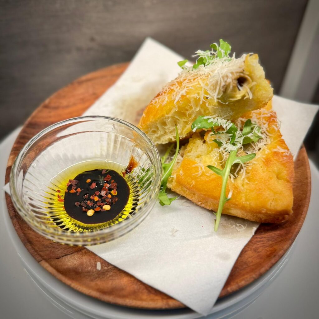 Olive focaccia with rocket and Grana Padano at Nesso Leeds