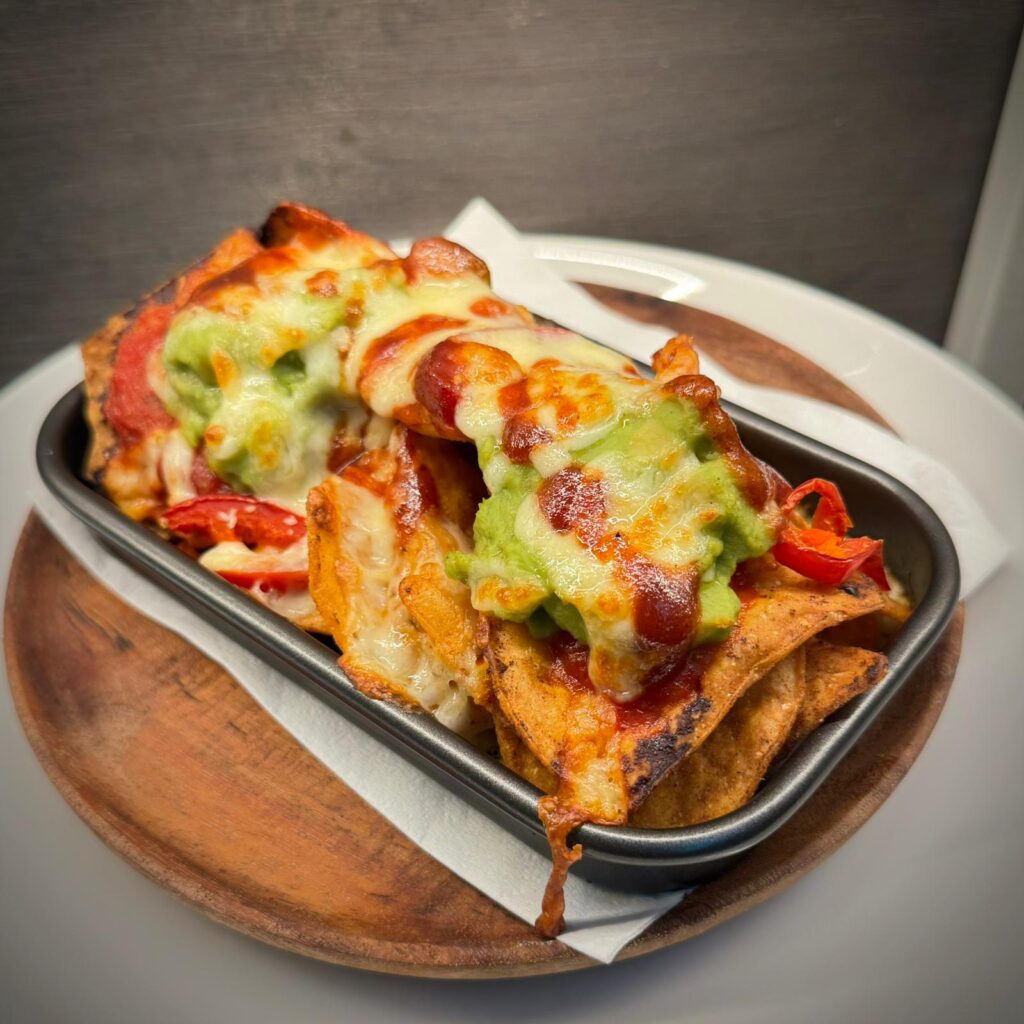 Oven-baked vegetarian nachos with smashed avocado at Nesso Leeds city centre